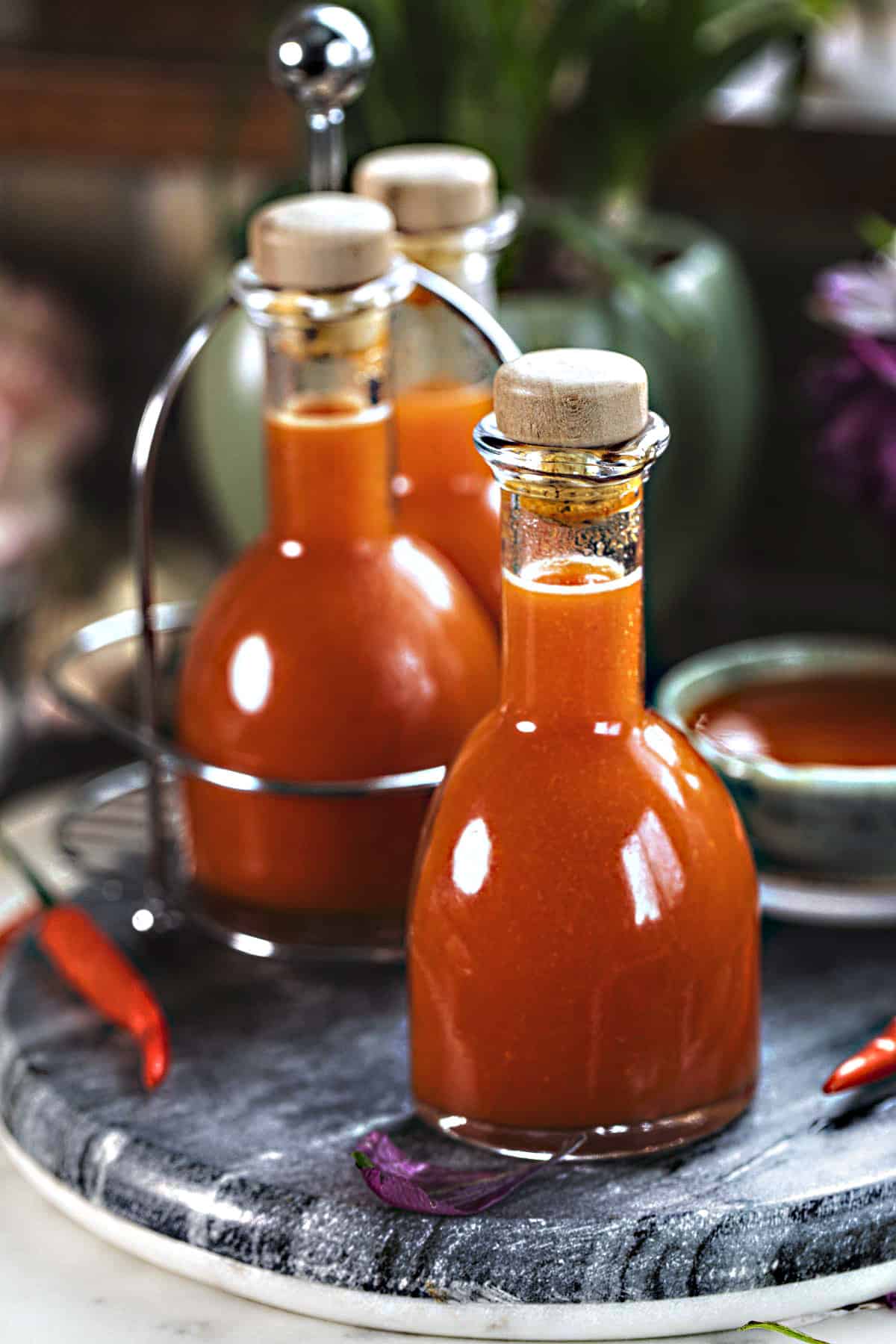 Thai sriracha in bottles on the counter. 