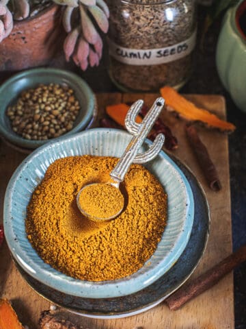 easy yellow curry powder in a bowl on a cuting board.