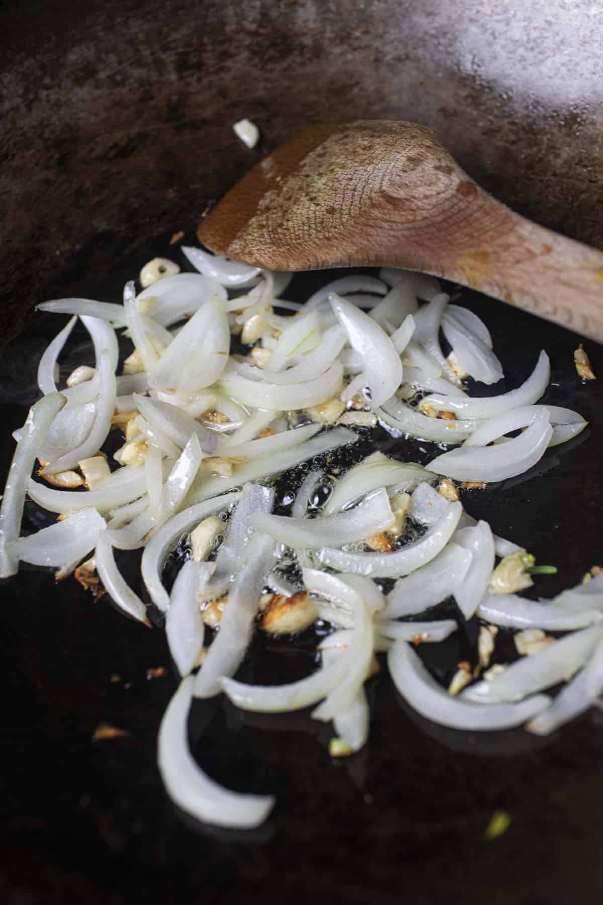 onion and garlic caramelized in a wok. 