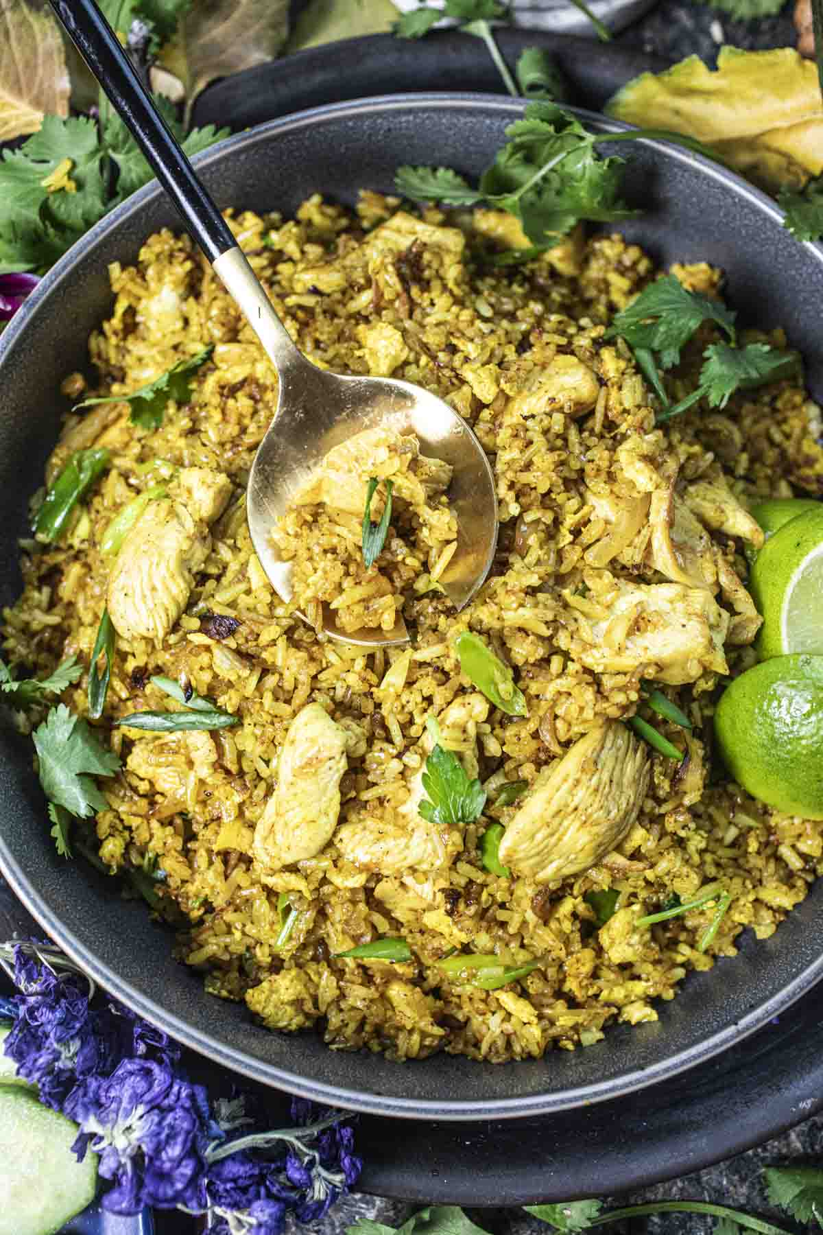 Thai yellow fried rice with spoon in the middle.