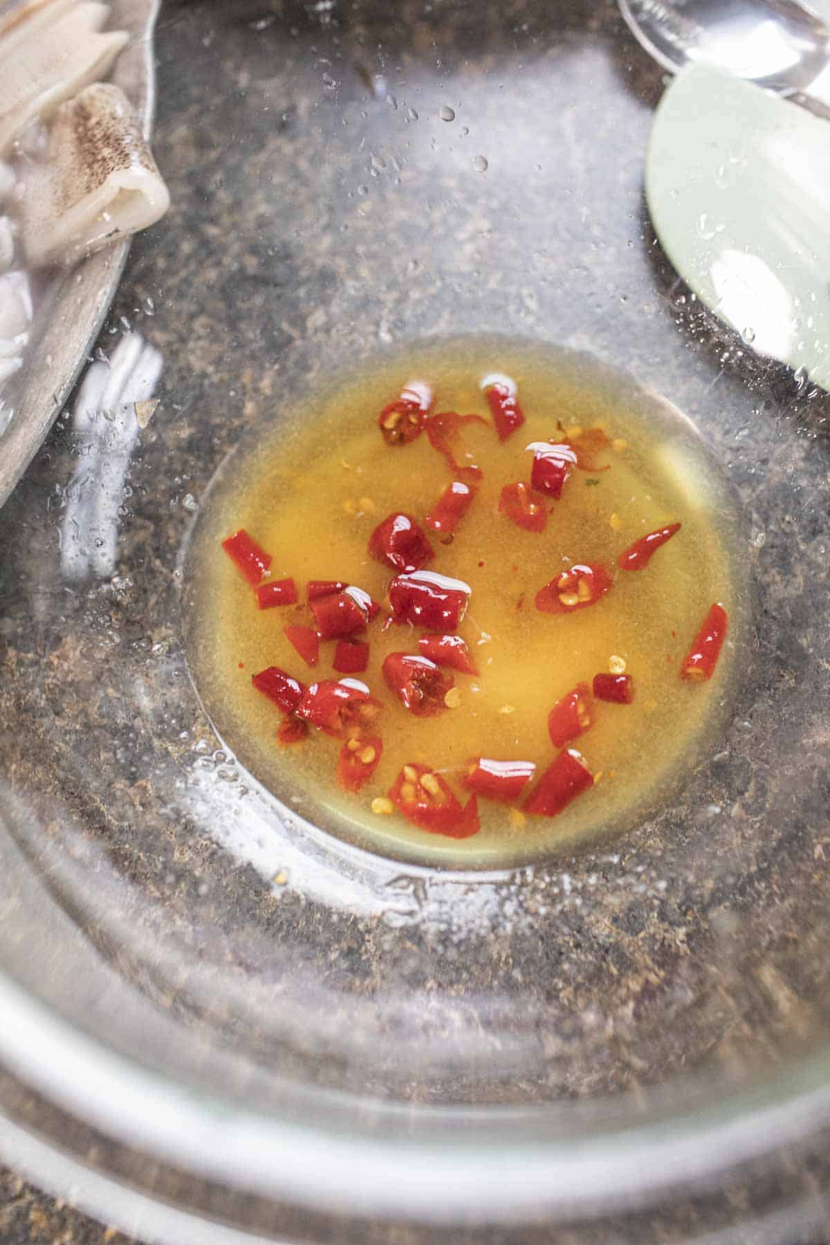 Salad Dressing for Thai seafood salad in a glass bowl. 