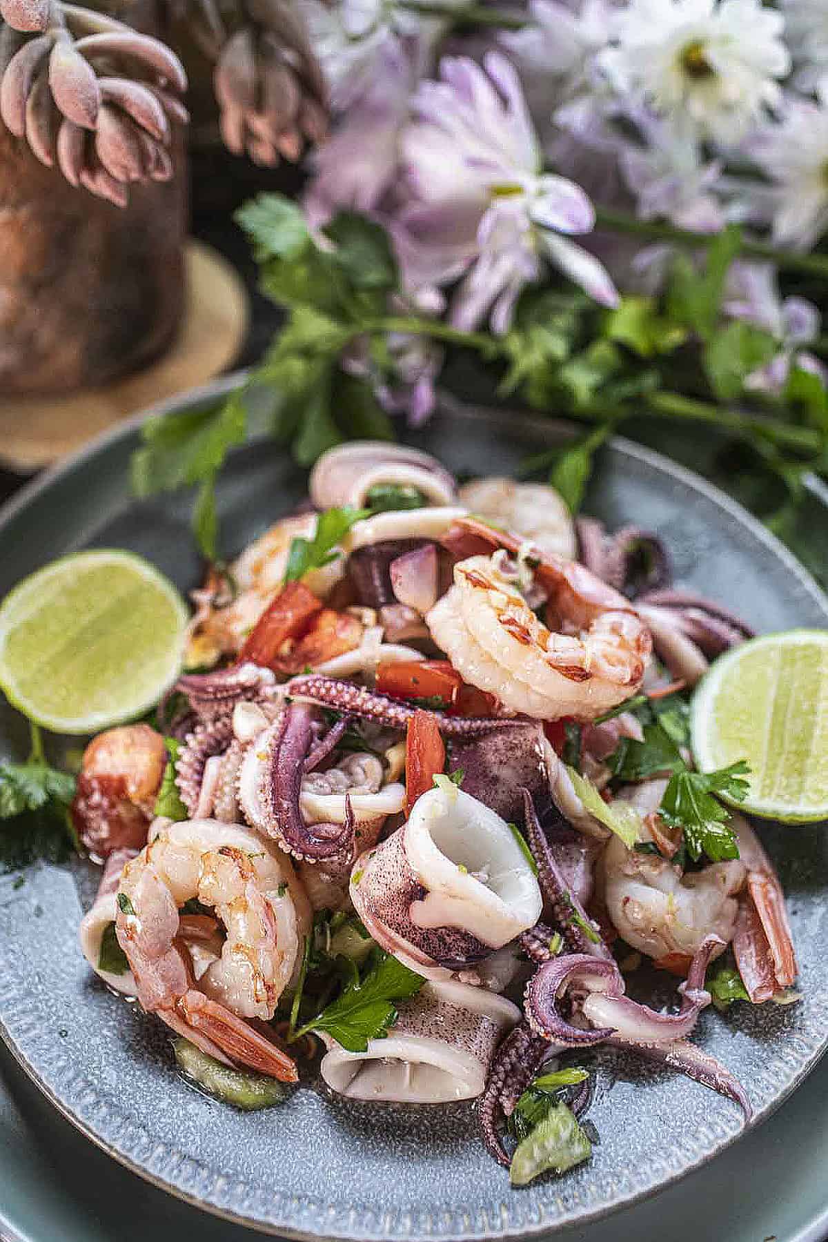 Thai seafood salad on a platter on the table. 