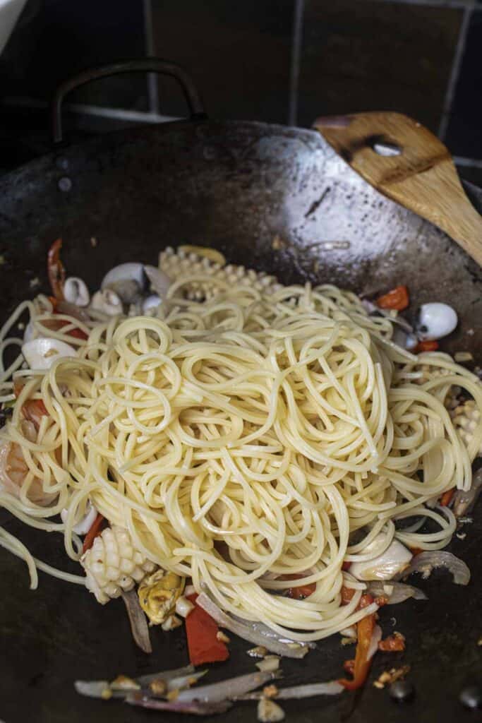 Spaghetti noodles in a wok. 