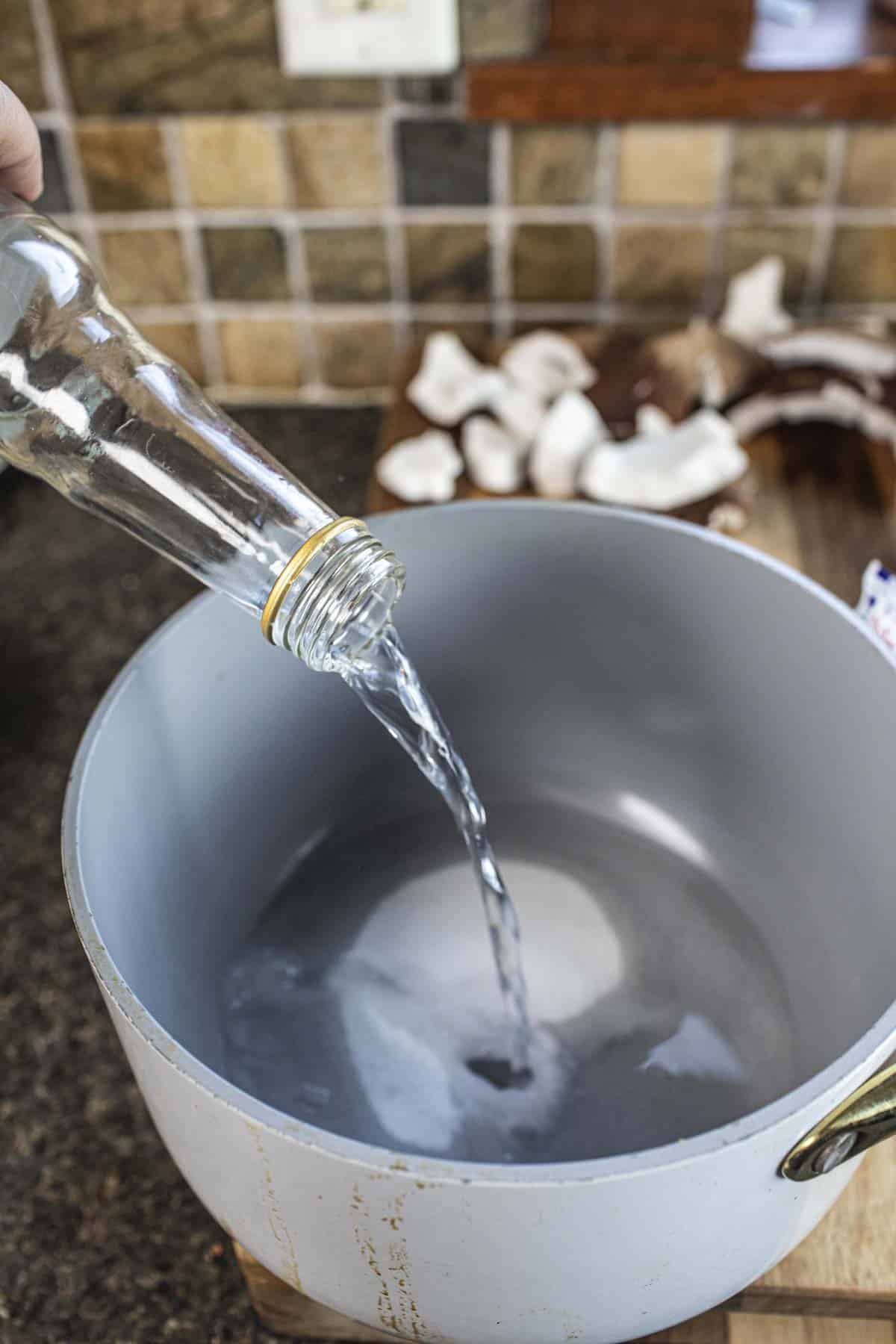 Jasmine water pouring into a pan with coconut jelly.