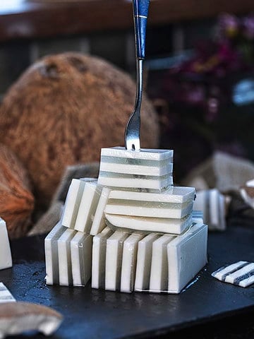 Coconut jelly dessert cubes on a tray.