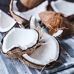 cracked coconut meat on shelf on a towel.