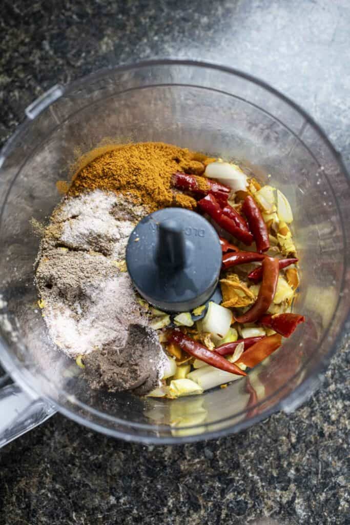 khao soi ingredients in a food processor. 