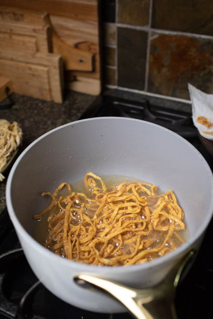 crispy fried Khao Soi noodles in oil. 