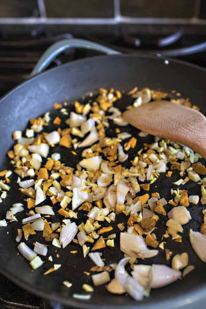 Toasted ginger, onion and turmeric in a pan. 