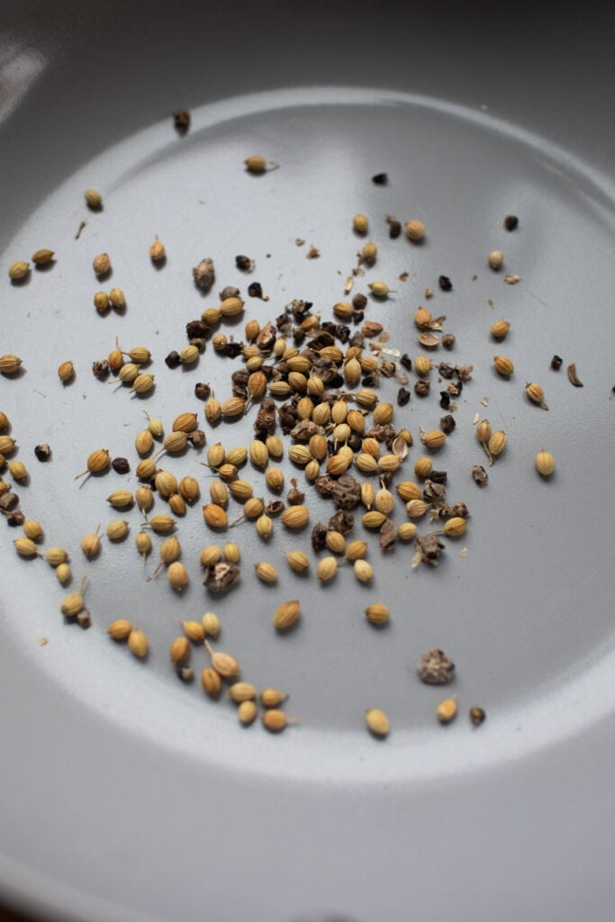 Toasted spices for khao soi paste in a pan. 