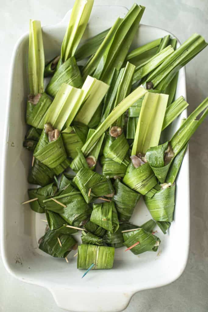 pandan leaves wrapped chicken on a tray.