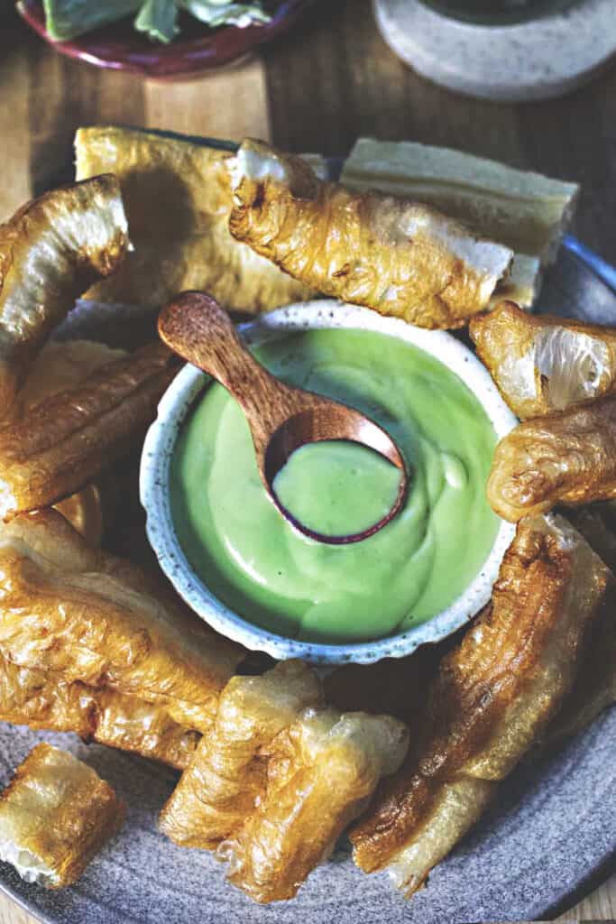 a spoon inside a Thai green pandan custard dessert.