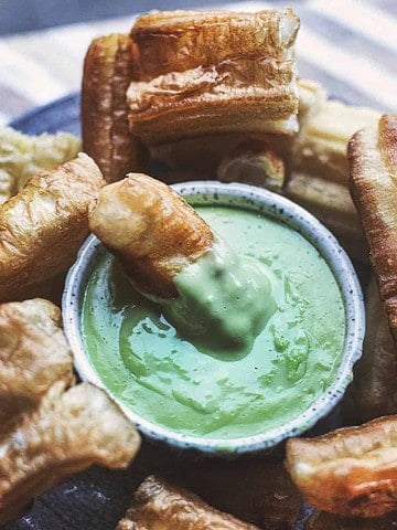 Thai pandan custard with a donut dipped in the bowl.