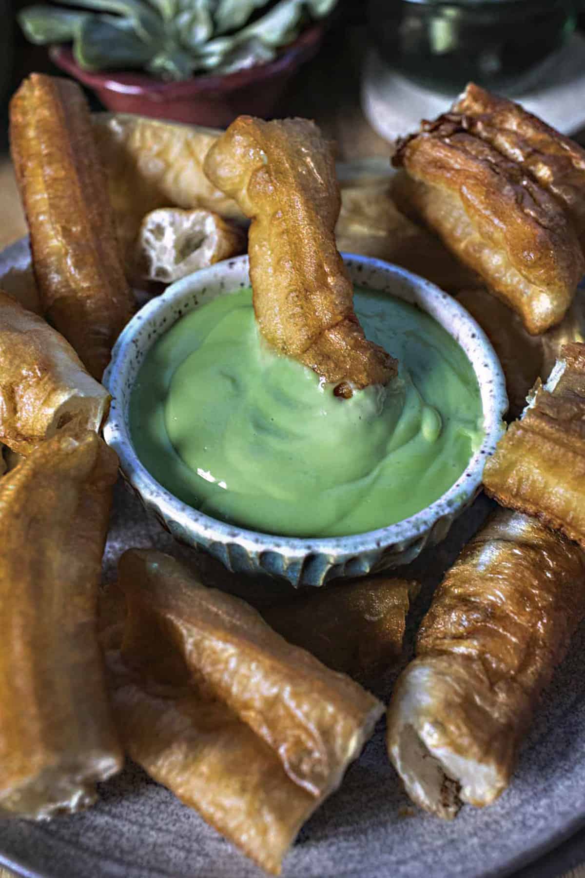 Donut dipped in green Sankaya custard. 