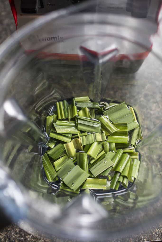 Small pieces of pandan leaves inside a food processor.