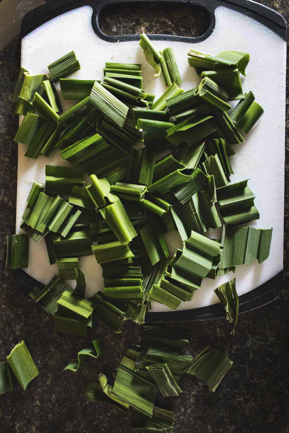 Chopped pandan leaves on a cutting board. 