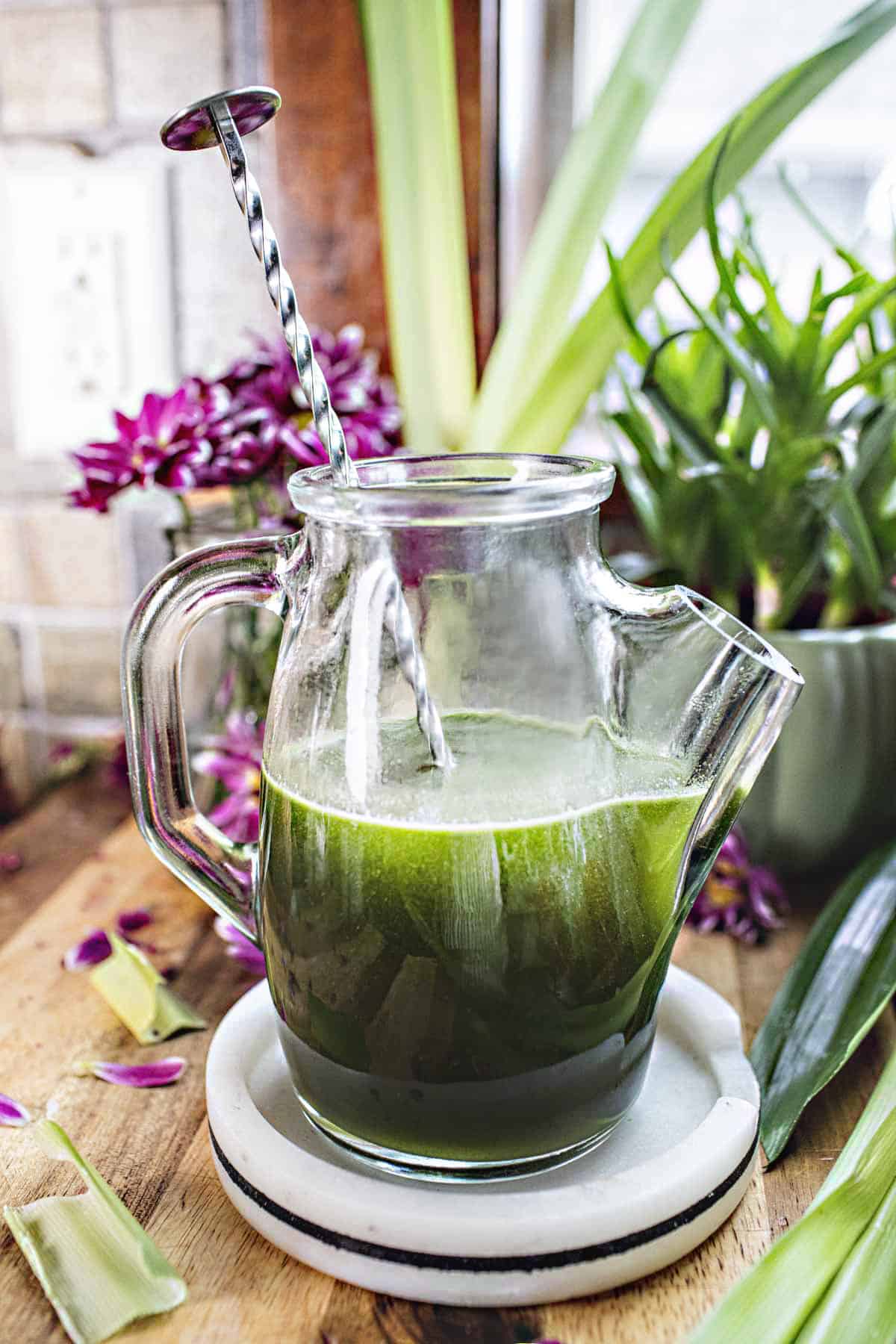 Pandan simple syrup in a glass vase.