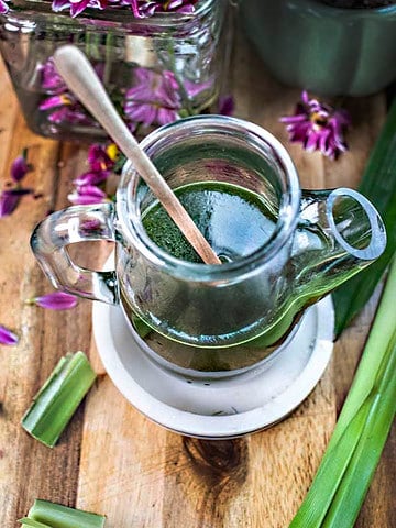 A spoon inside a vase with pandan syrup.