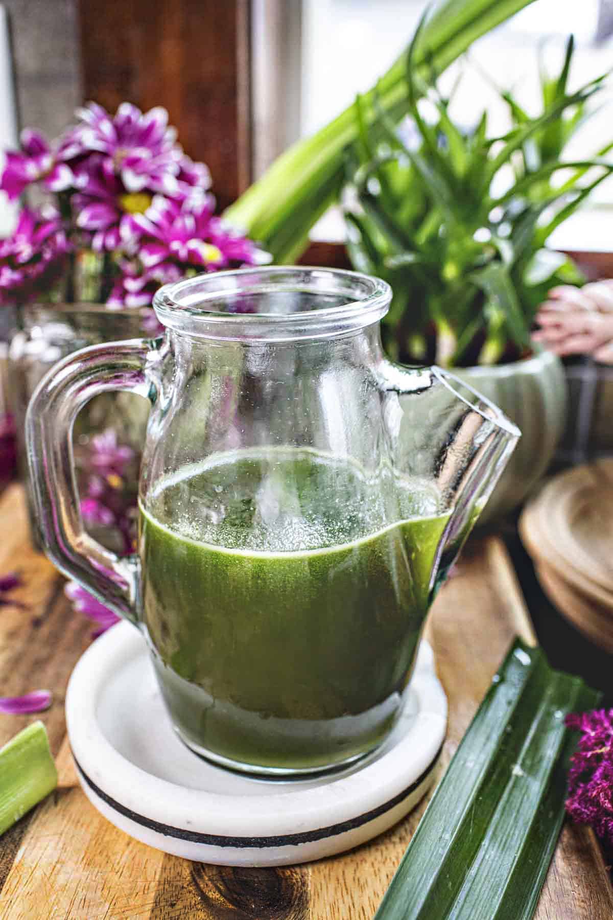 Pandan simple syrup in a glass vase.