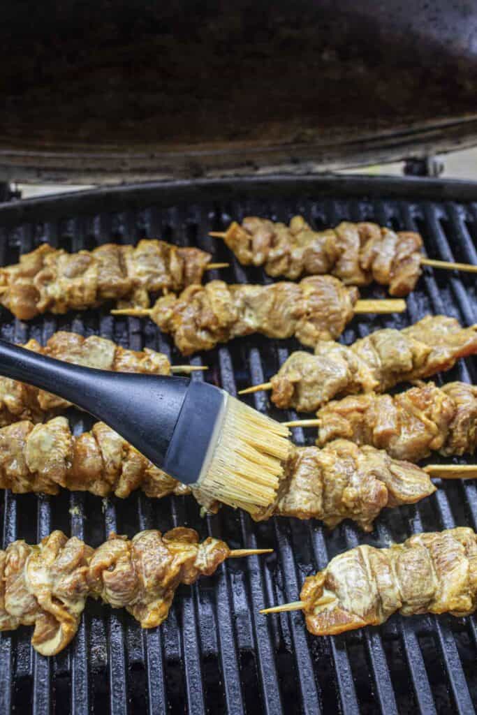 Grileld pork skewers on a grill. 