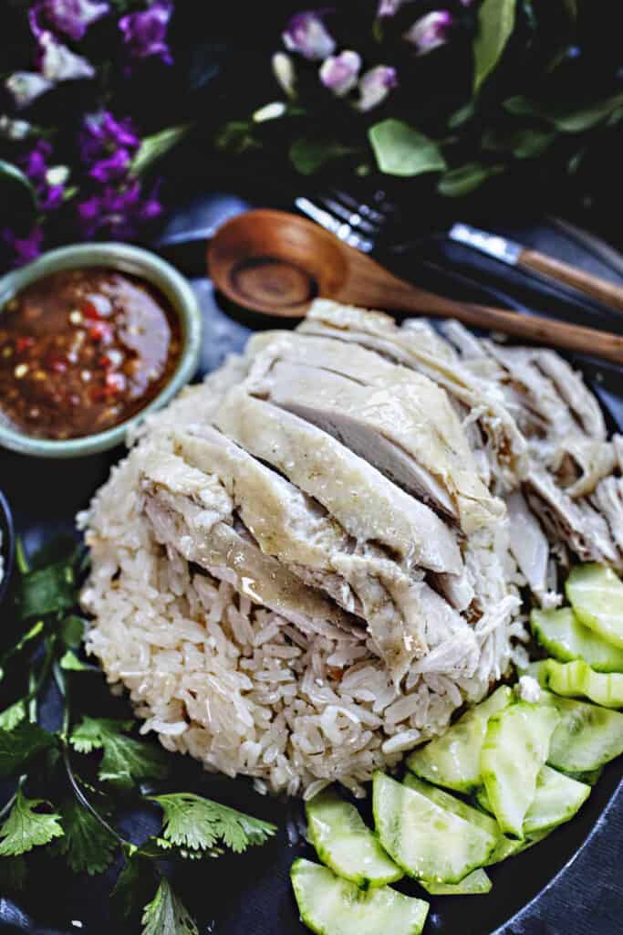 Khao mun gai chicken slices over rice on a platter. 