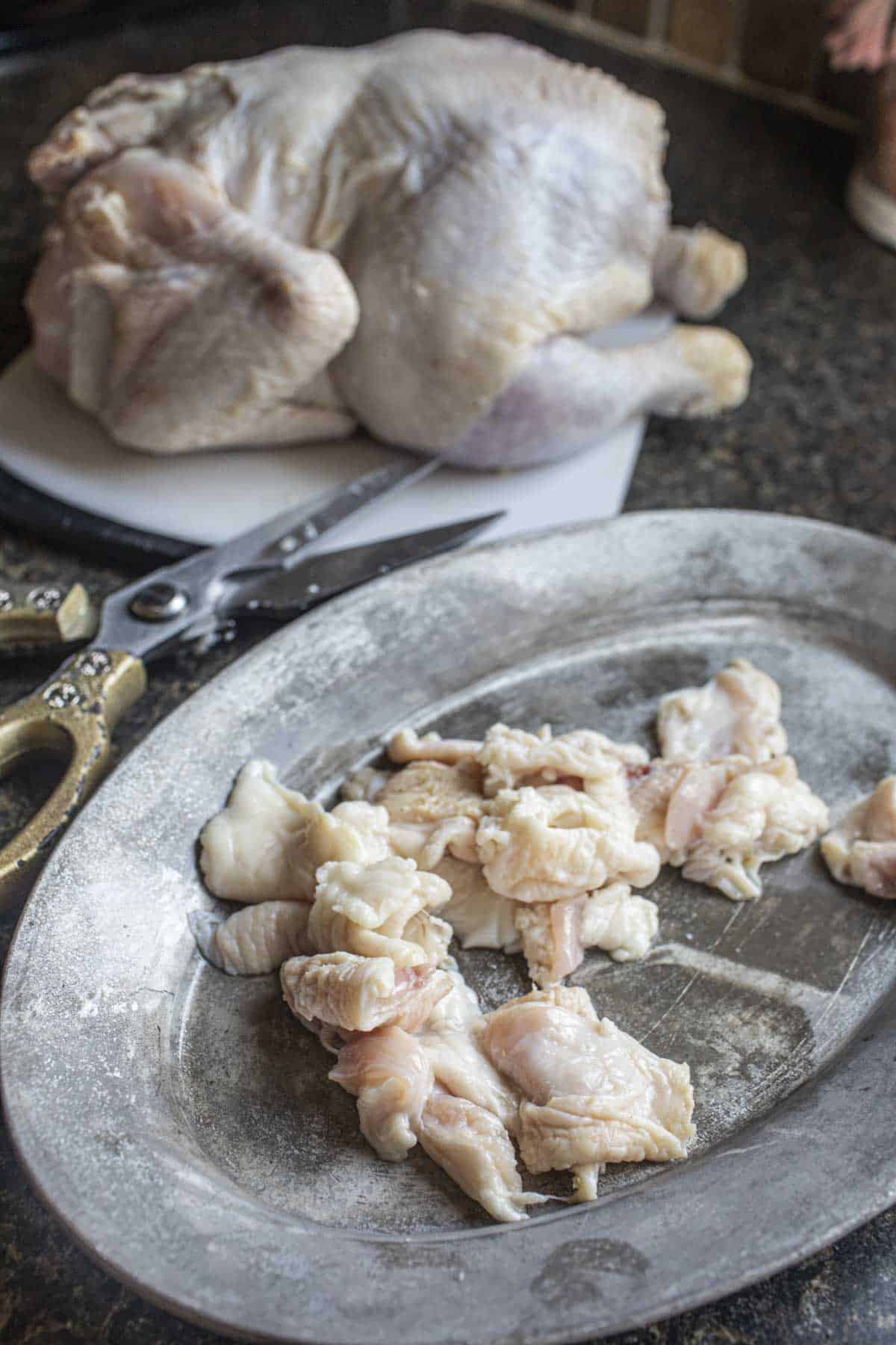 Trimmed chicken fat on a plate. 