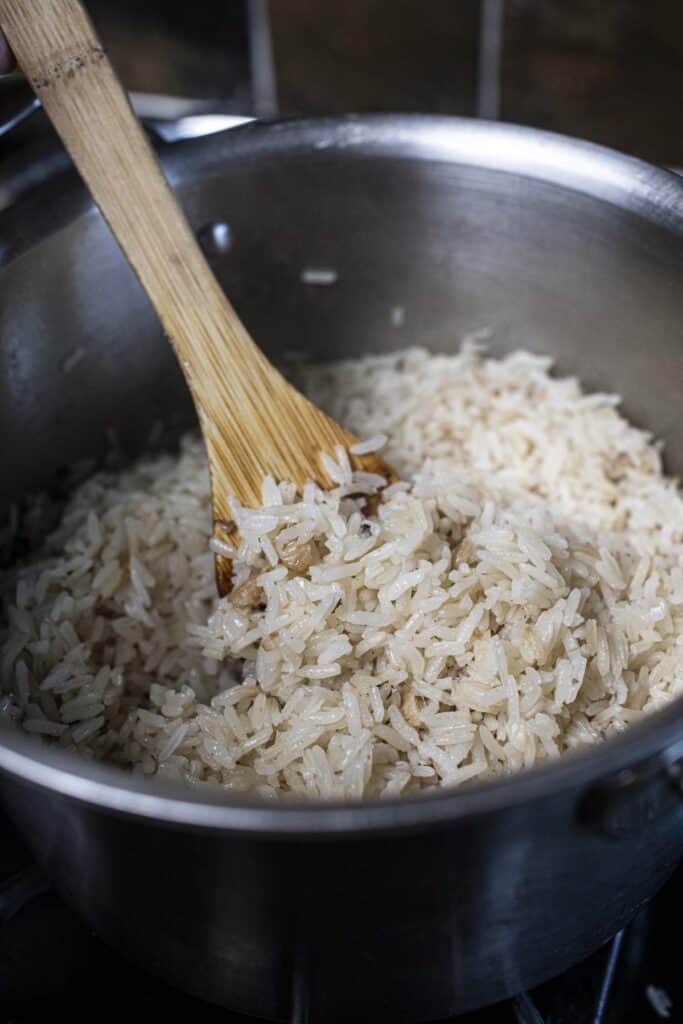 Spatula in rice in a pot.