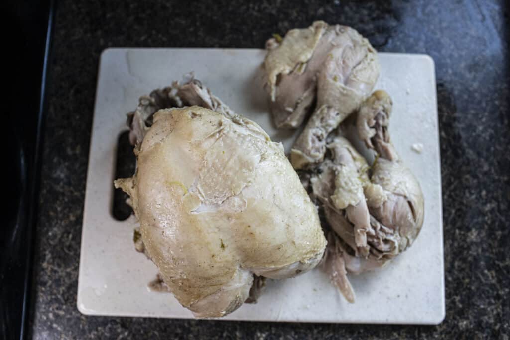 Cooked whole chicken on a cutting board. 