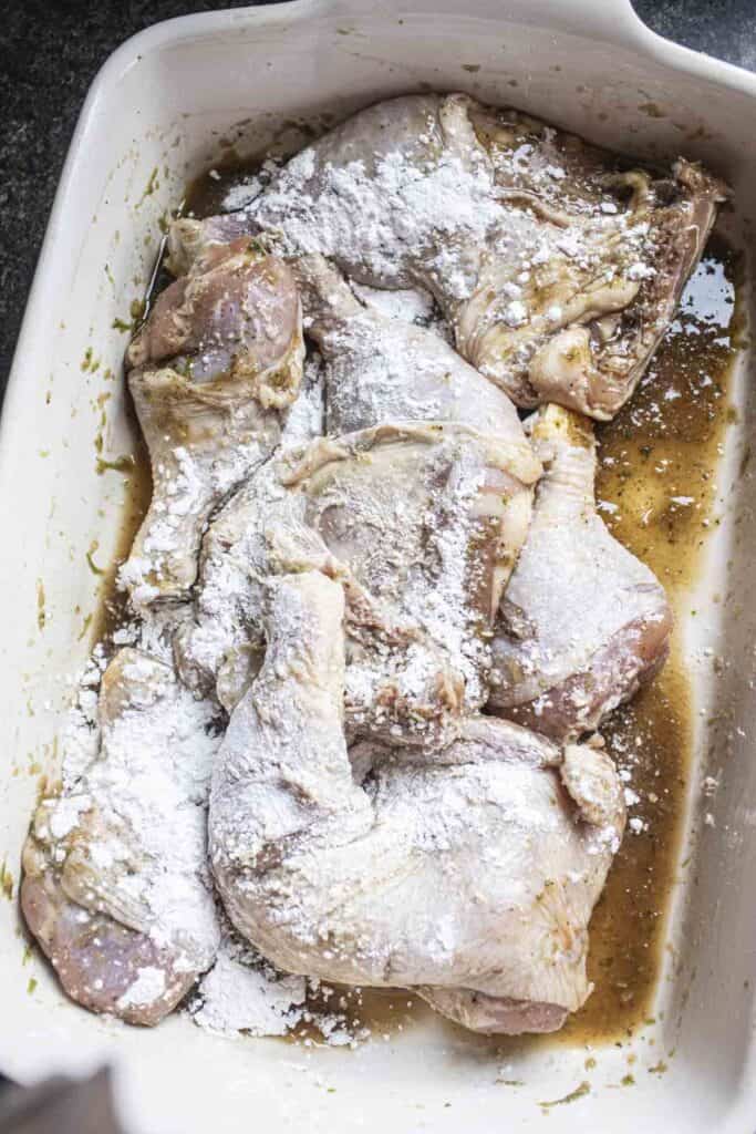 chicken pieces coated in rice flour in a large bowl.