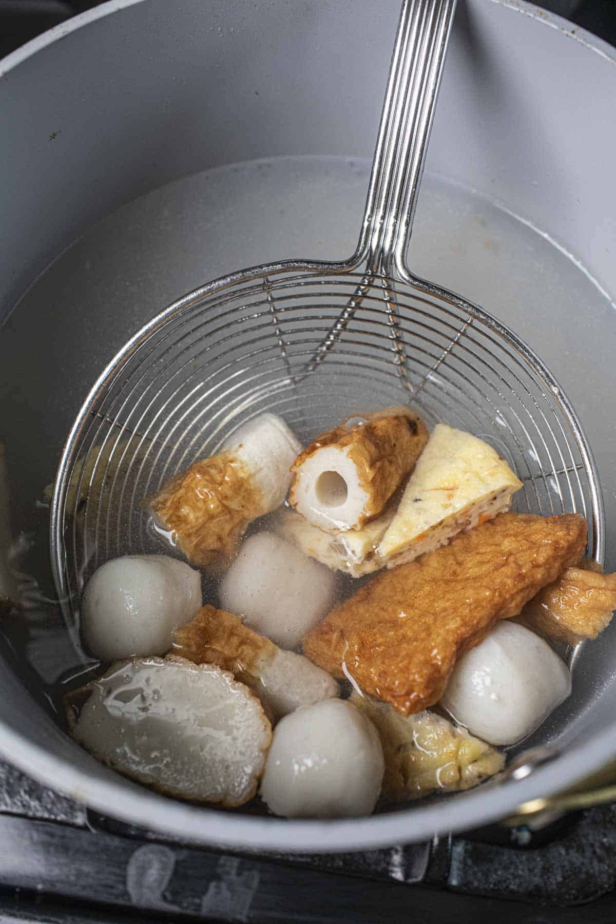 Fish cakes and fish balls in a pot.