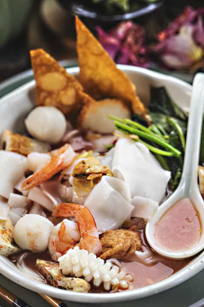 Thai pink soup in a bowl with a spoon. 