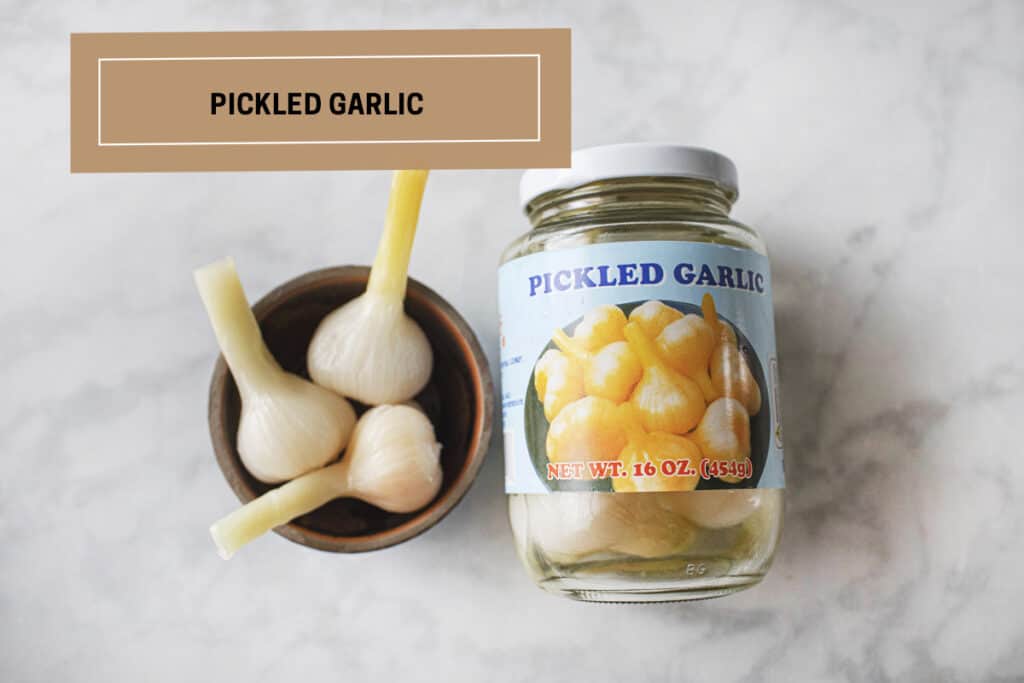 Thai Pickled garlic in a jar and a bowl. 