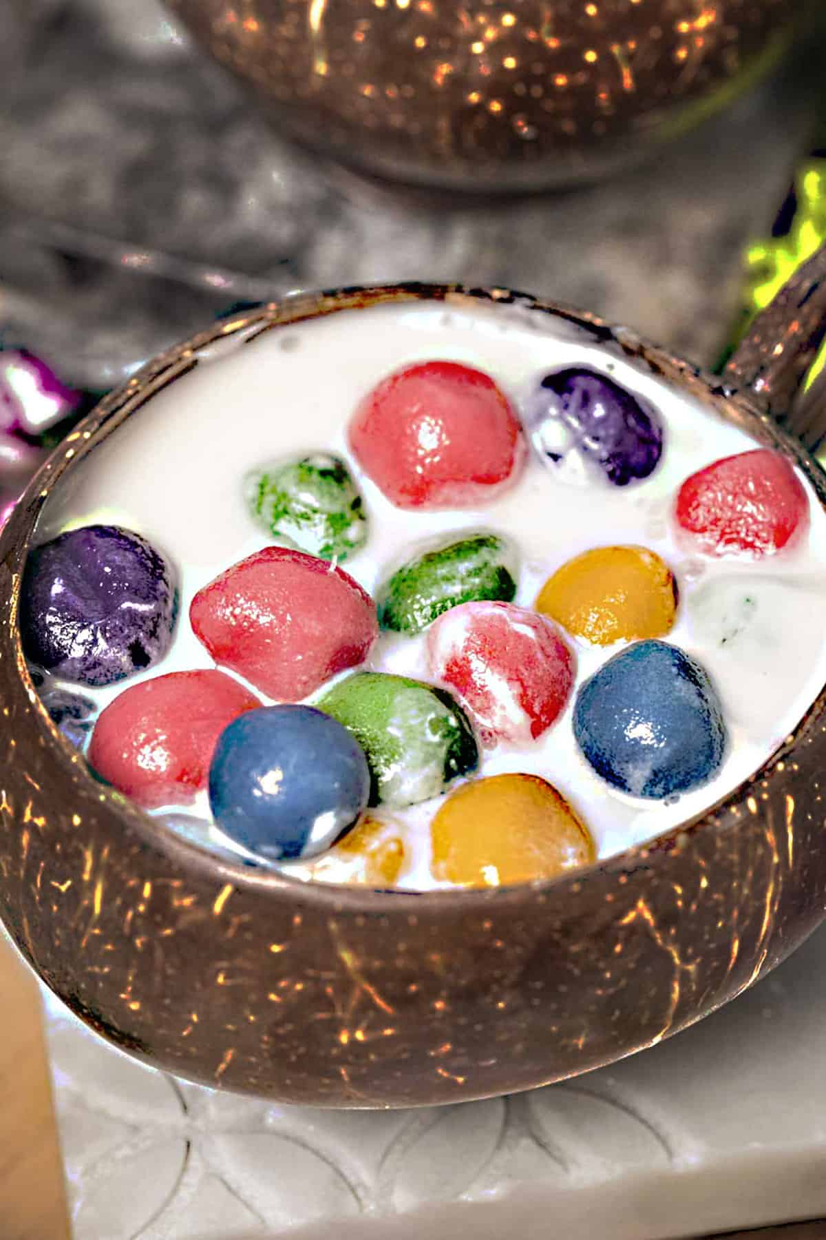 Thai glutinous rice balls in a coconut bowl. 