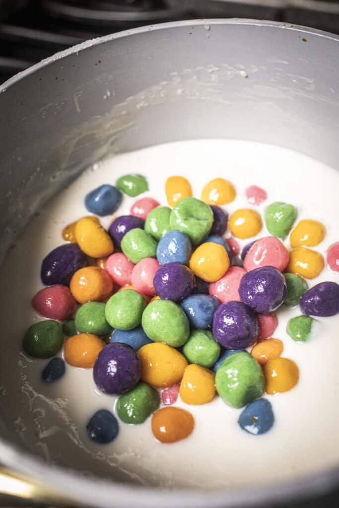 Thai glutinous rice balls in coconut milk sauce in a pot. 