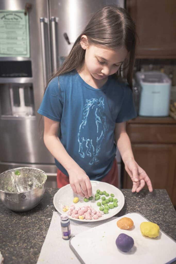 Little girl making tapioca pearls on the counter. 