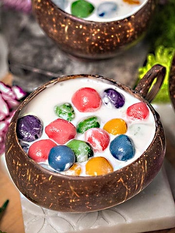 Bua Loi dessert in a coconut bowl.