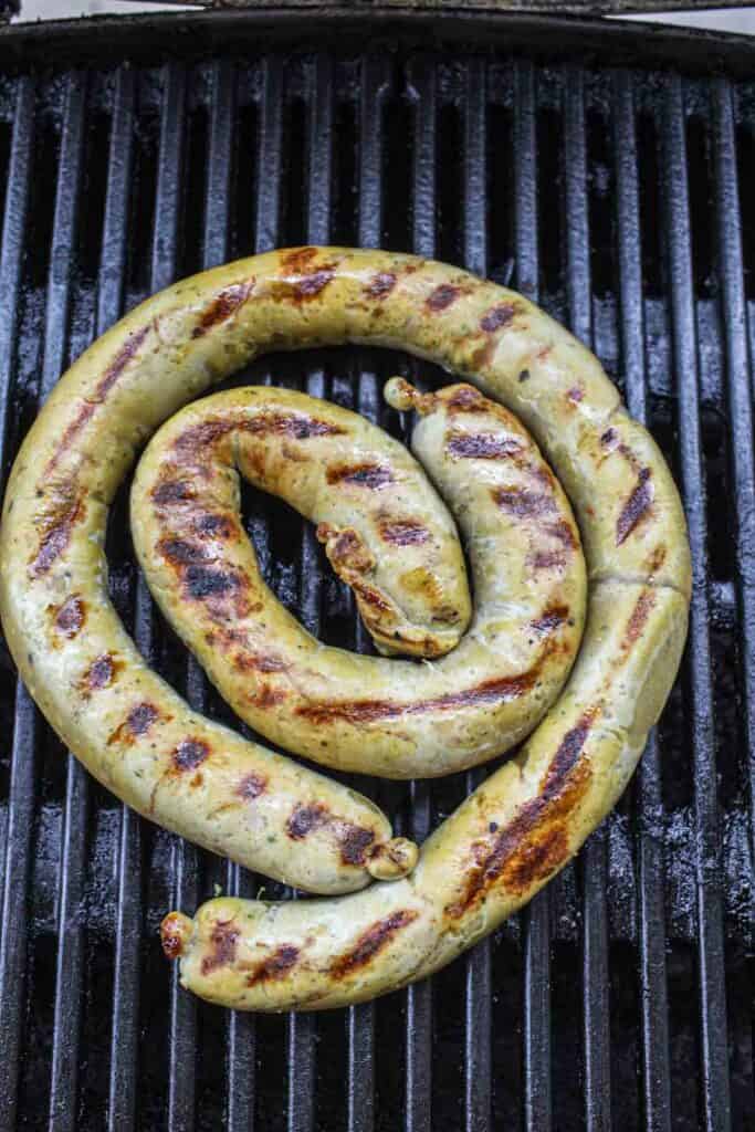 Long coil of Sausage on a grill. 