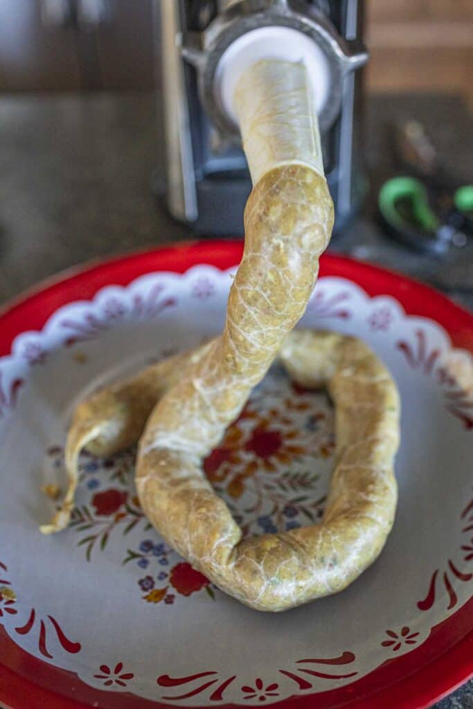 Sausage stuffe stuffing meat into casing. 