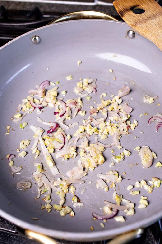 Garlic, shallot and ginger sauteeing in a pan. 