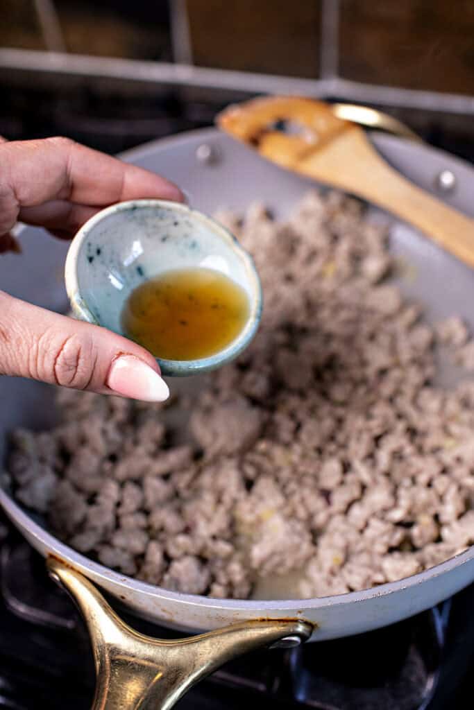 Thai ground pork in a pan on the stove. 