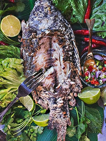 Thai salted fish on a bed of vegetables.
