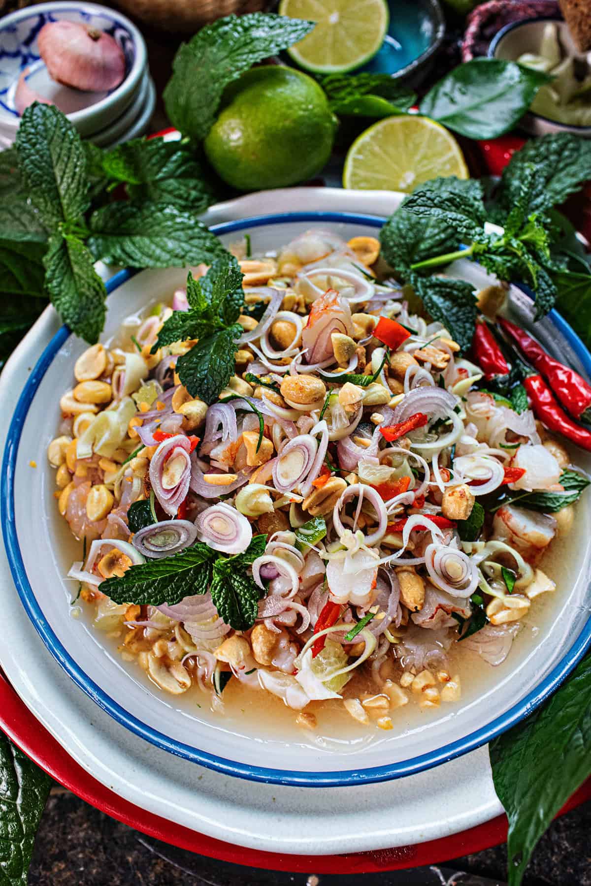 Thai Yum takrai salad on a platter with herbs on the side. 