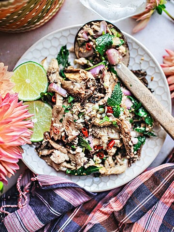 Oyster mushroom larb on a plate on the table.