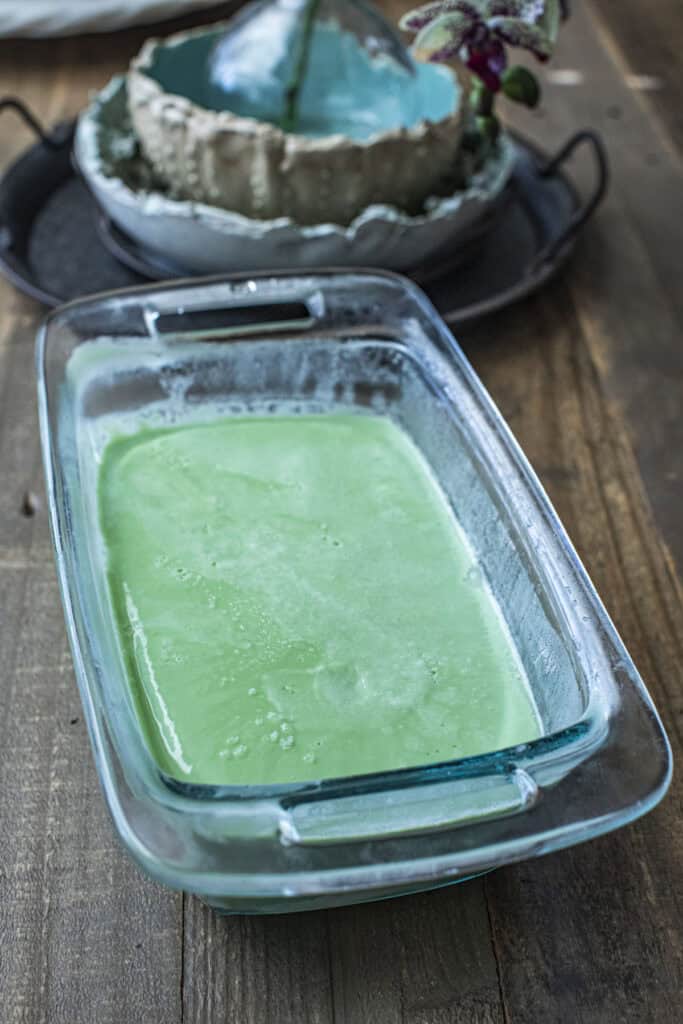 Frozen green ice cream in a glass bowl. 