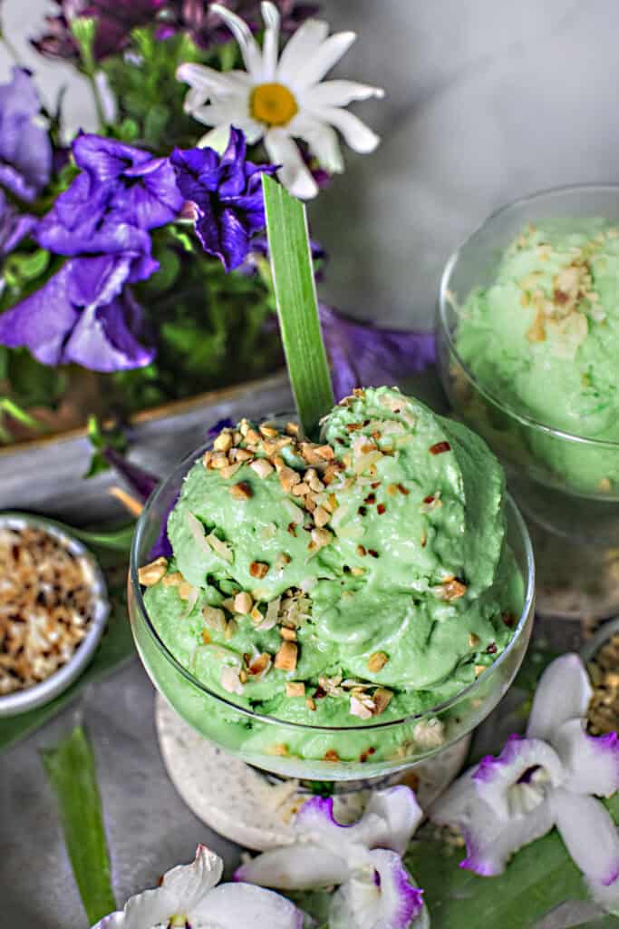 Pandan coconut ice cream with nuts in a bowl.