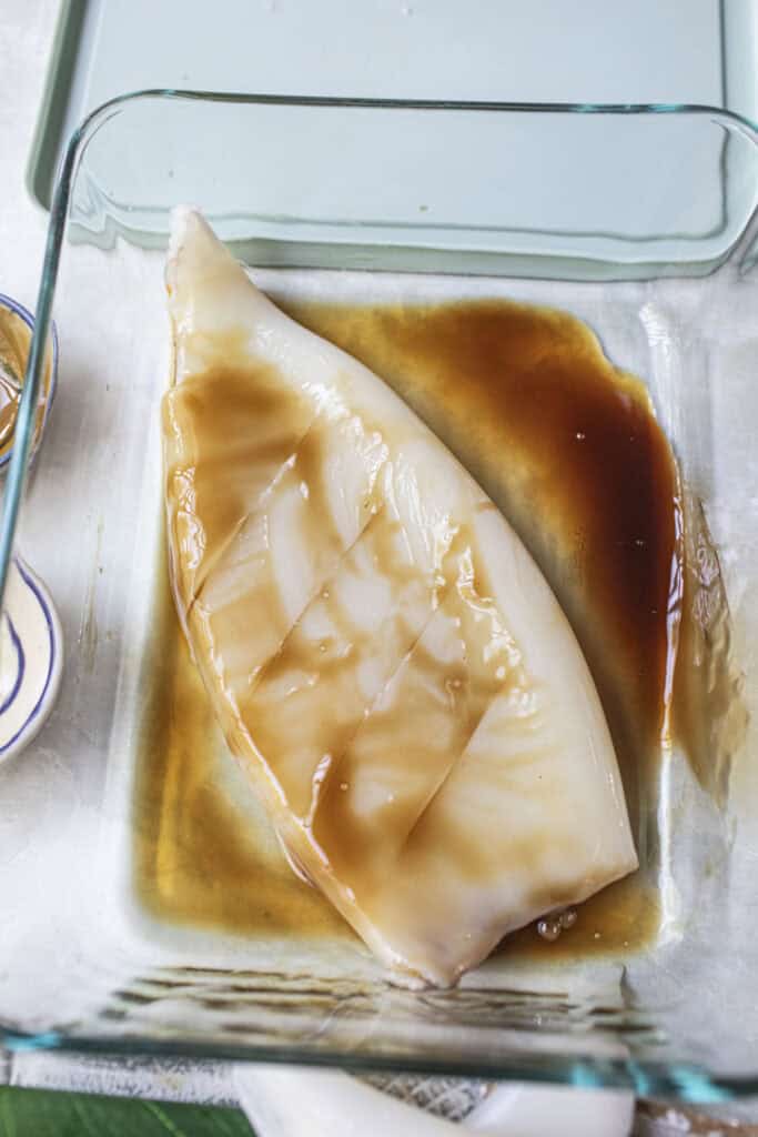 Marinade squid in a pan with sauce. 