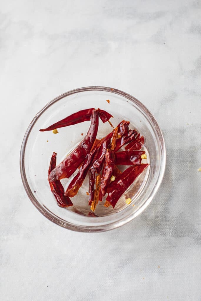 Thai red chilis soaked in a bowl of water. 