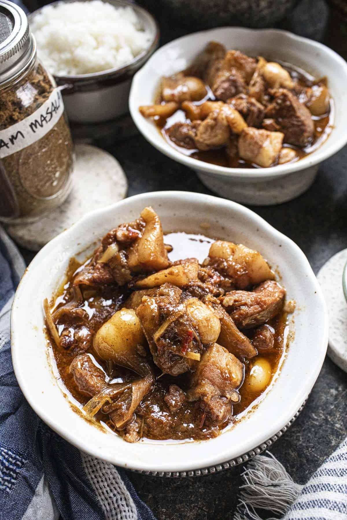 Pork Hang Lay curry in two white bowls on the table. 
