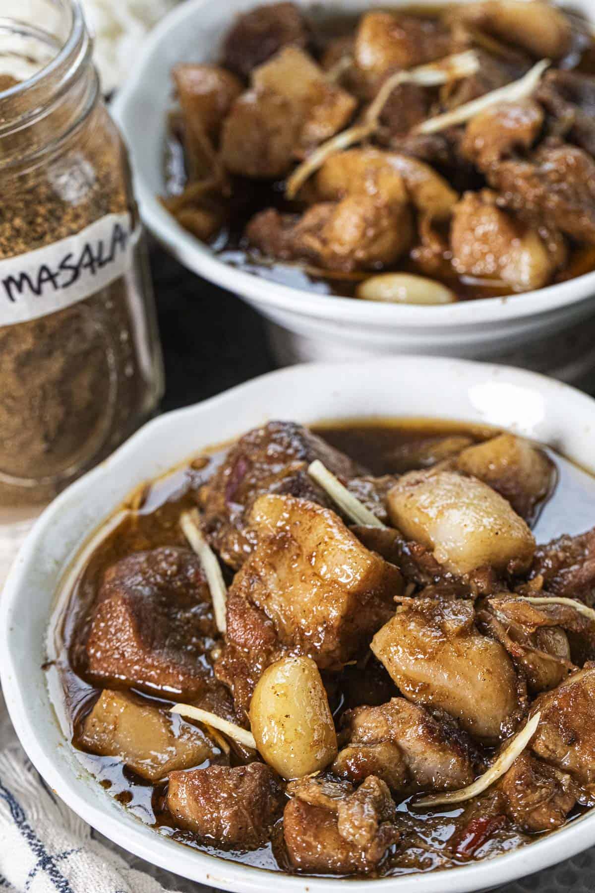 Two bowls of Hunglay curry on a table. 