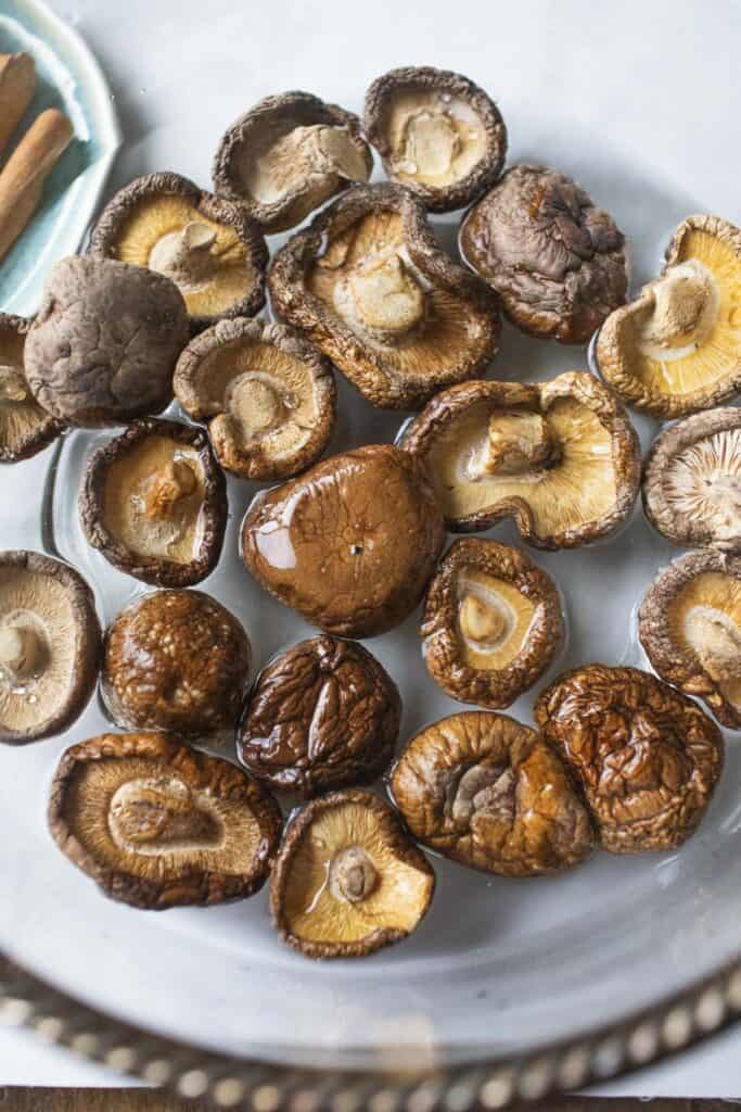 Dried shikake mushrooms soakig in water. 